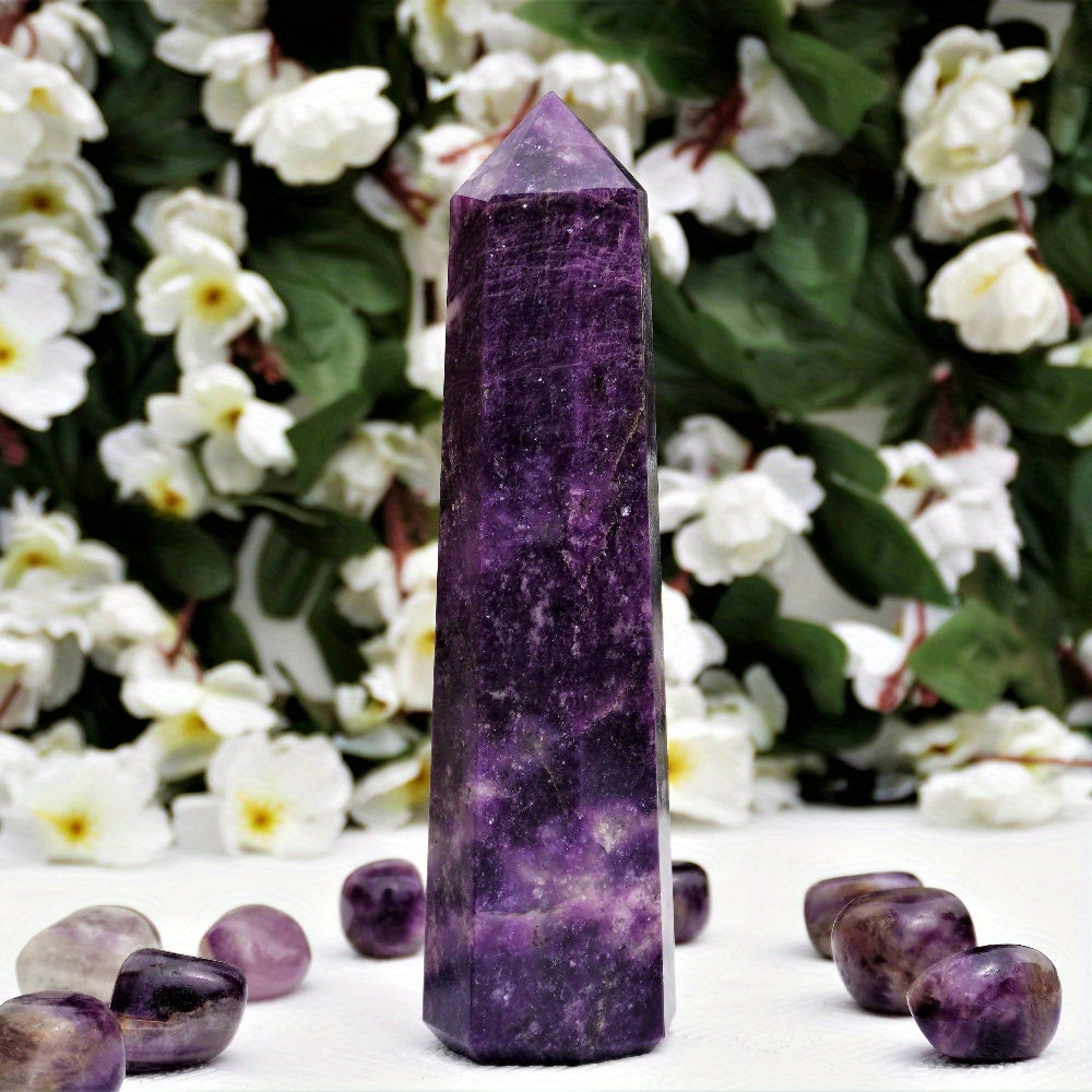 Tall Lepidolite crystal tower surrounded by polished tumbled stones, placed in front of a lush floral background for a peaceful and serene setting.