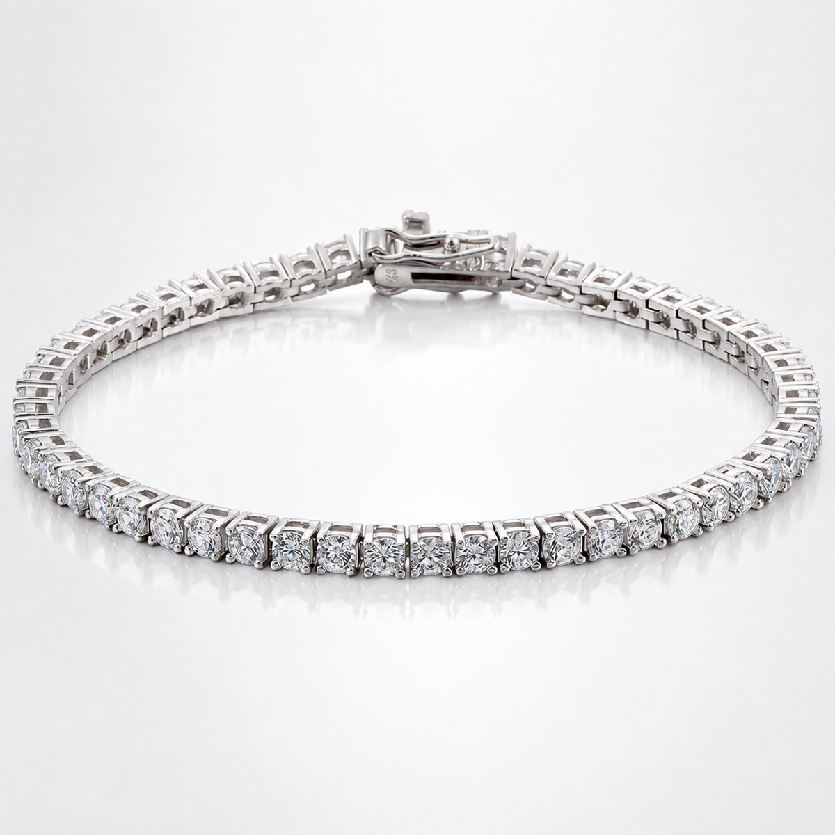 Silver-tone classic moissanite tennis bracelet with round stones and box clasp on a white background