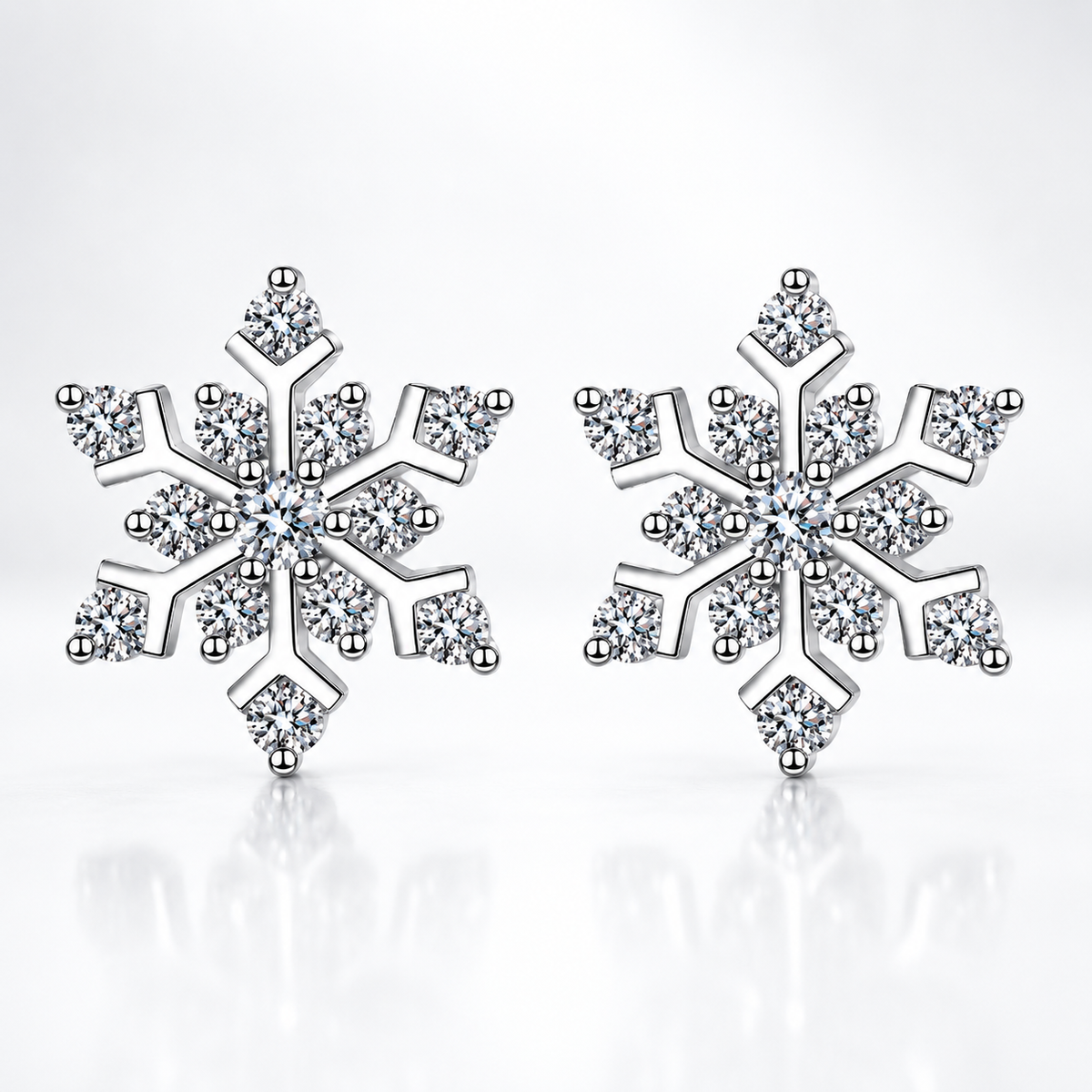 Silver snowflake moissanite stud earrings on a white background