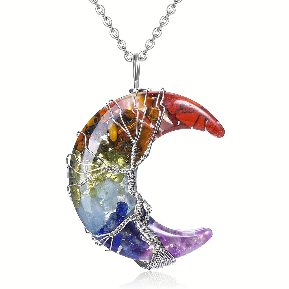 Crescent moon chakra pendant necklace wrapped with silver wire in a tree of life design, featuring embedded gemstones aligned with the seven chakras.