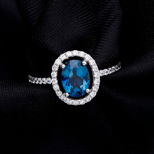 "The Eye of London" 8x6mm Oval Cut Natural London Blue Topaz Halo Ring - Premium Jewelry from Dazzling Delights - Just $109.95! Shop now at Dazzling Delights