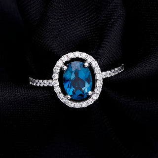"The Eye of London" 8x6mm Oval Cut Natural London Blue Topaz Halo Ring - Premium Jewelry from Dazzling Delights - Just $66.75! Shop now at Dazzling Delights