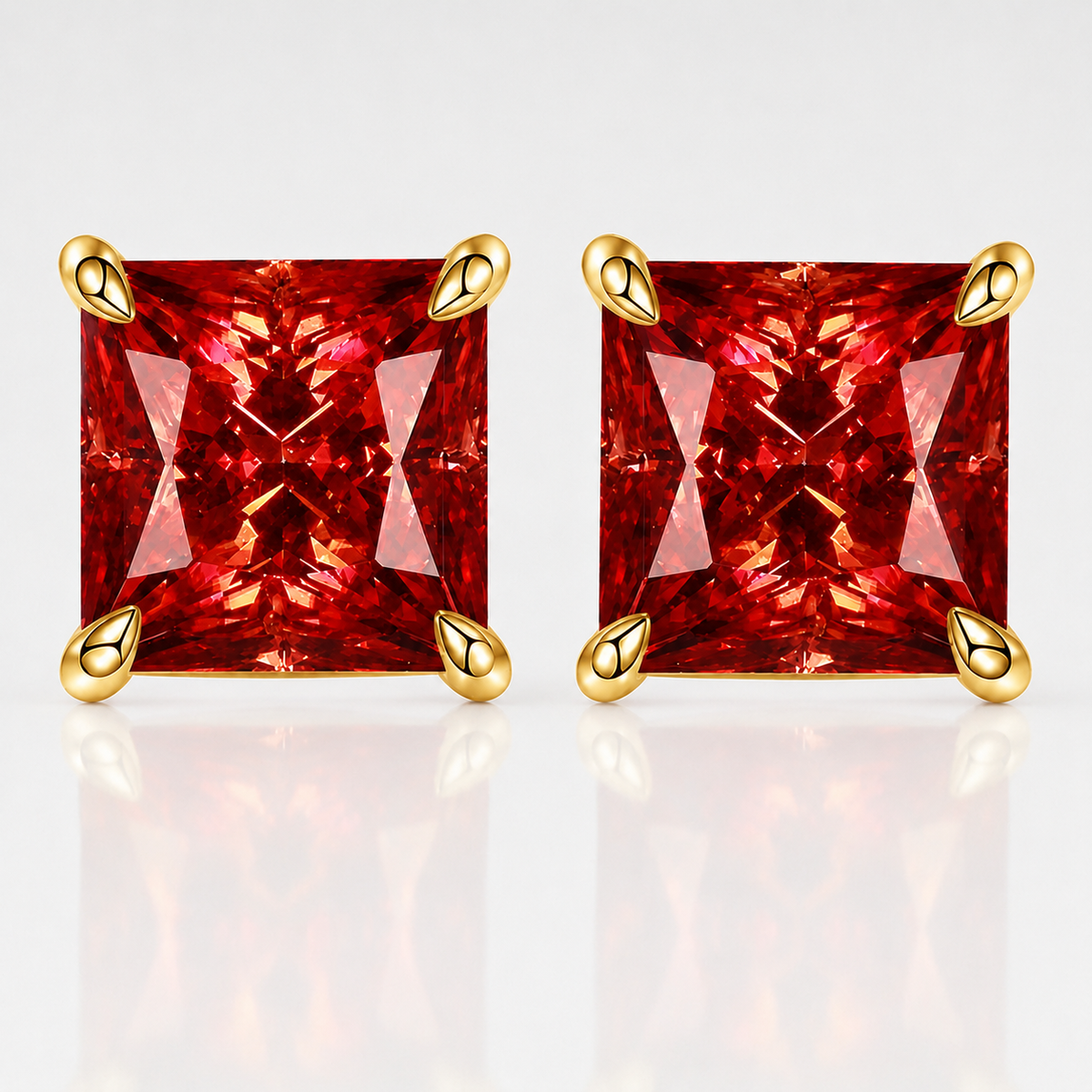 Gold princess-cut red moissanite stud earrings on a white background