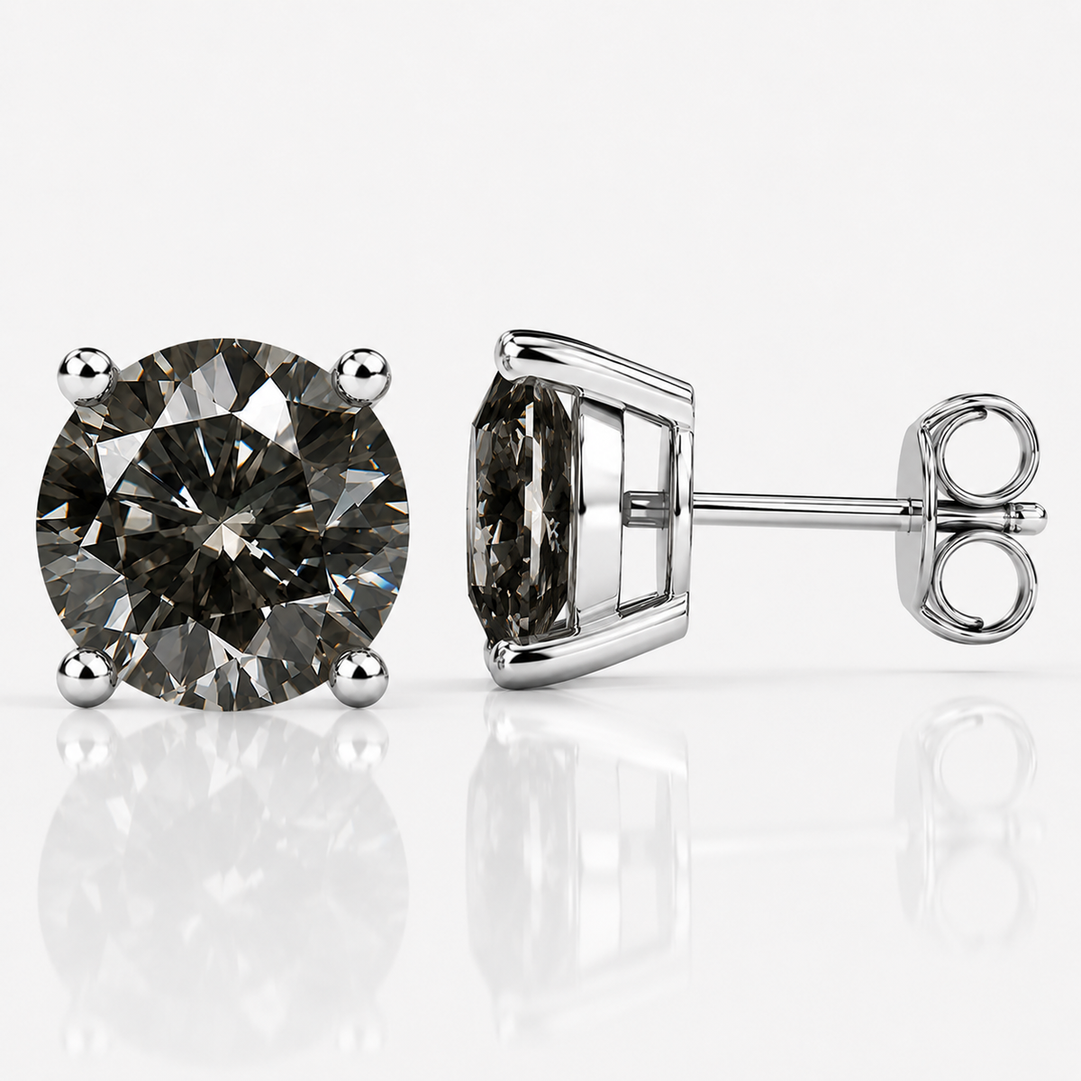 Silver four-prong grey moissanite stud earrings shown front and side on a white background