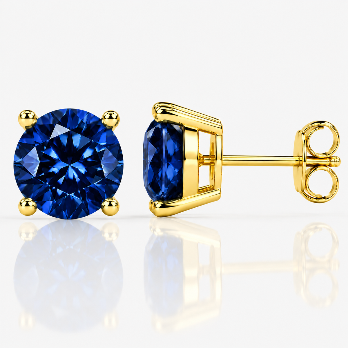 Gold four-prong royal blue moissanite stud earrings shown front and side on a white background