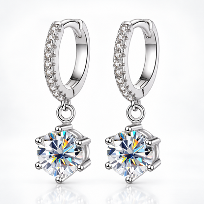 Silver pavé hoop drop earrings with round moissanite solitaires on a white background