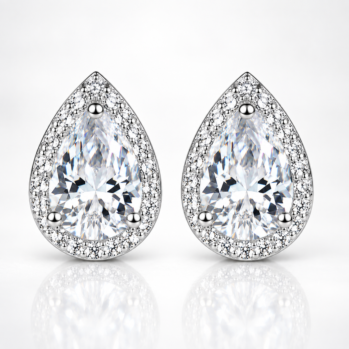 Silver pear-cut halo moissanite stud earrings on a white background