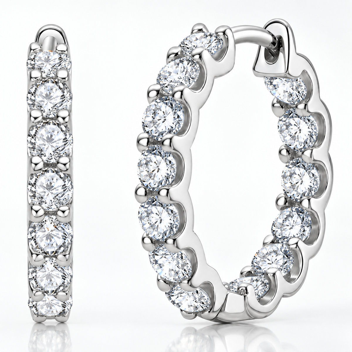 Silver inside-out moissanite hoop earrings with round stones on a white background