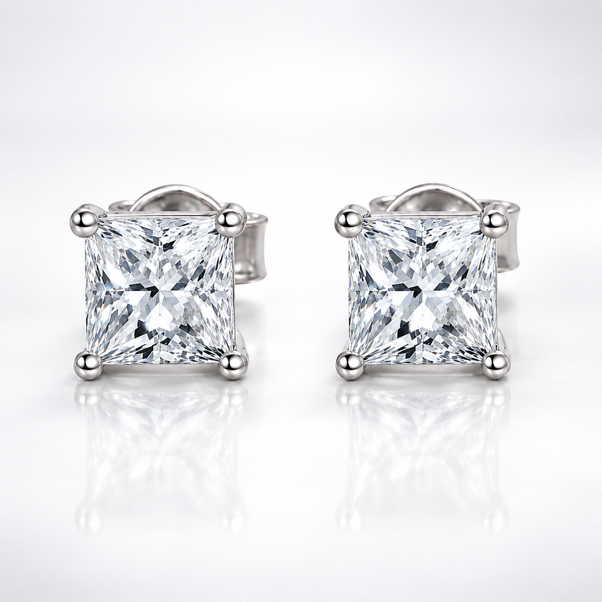 Silver princess cut colourless moissanite stud earrings shown front-on against a white background