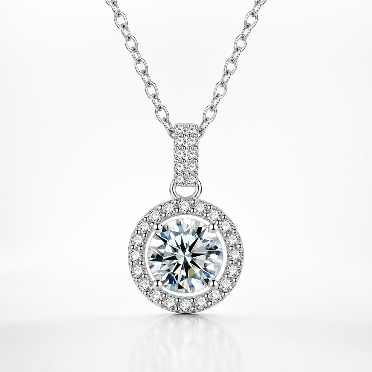 Silver round halo moissanite pendant necklace with a pavé halo and pavé bail on a white background.