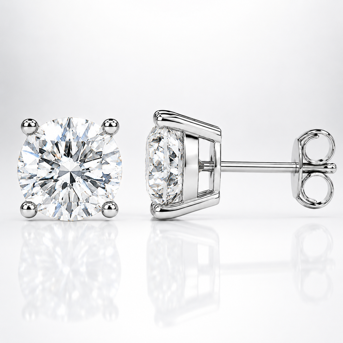 Silver four-prong colourless moissanite stud earrings shown front and side on a white background