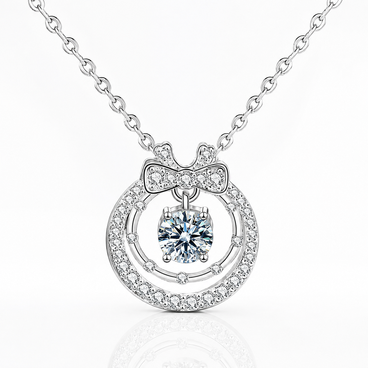 Silver floating halo moissanite pendant with a bow detail, double circular frame and suspended center stone.