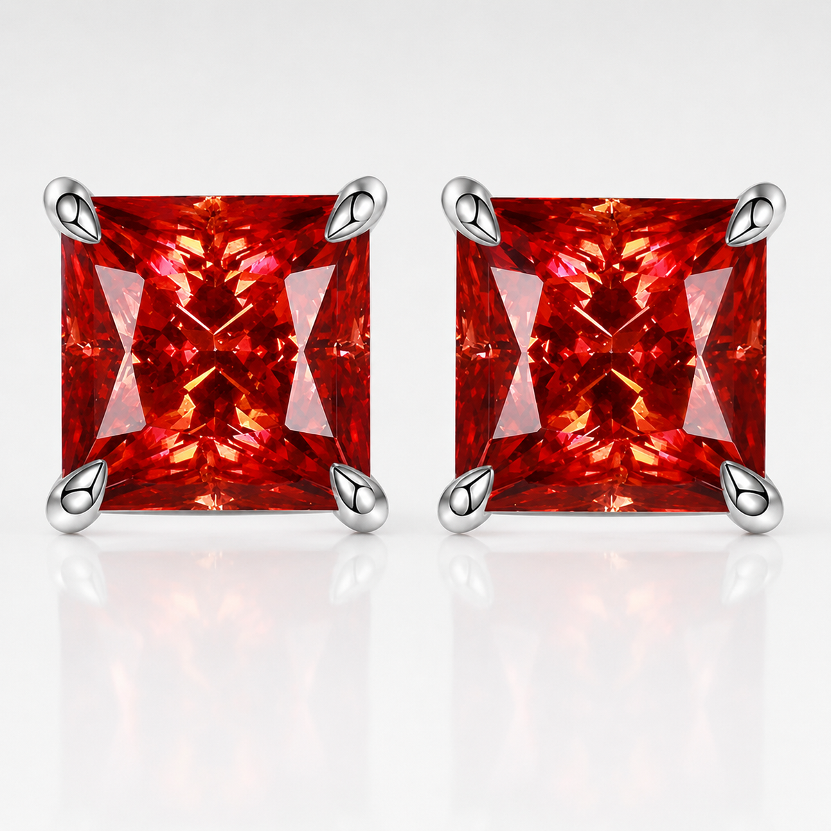 Silver princess-cut red moissanite stud earrings on a white background