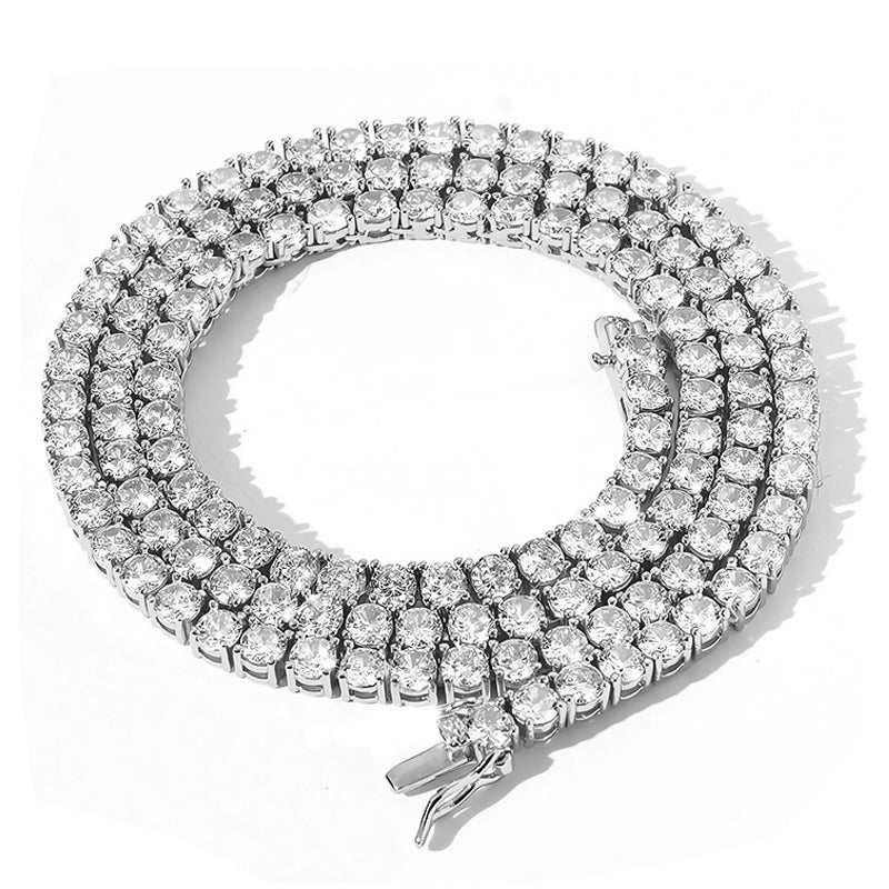 Silver moissanite tennis chain necklace arranged in a compact coil showing rows of round stones and the clasp.