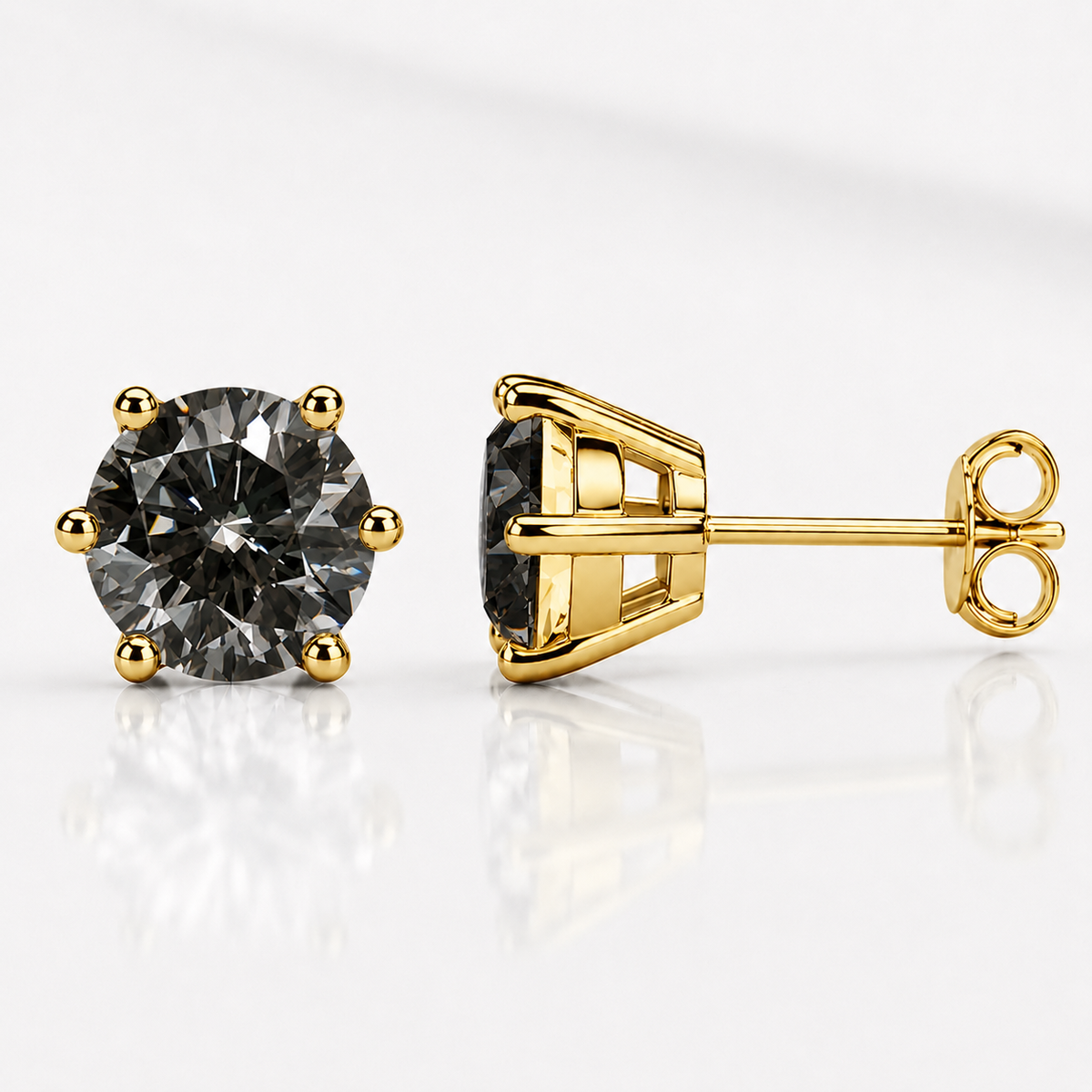 Yellow gold six-prong soft pink moissanite stud earrings shown front and side on a white background