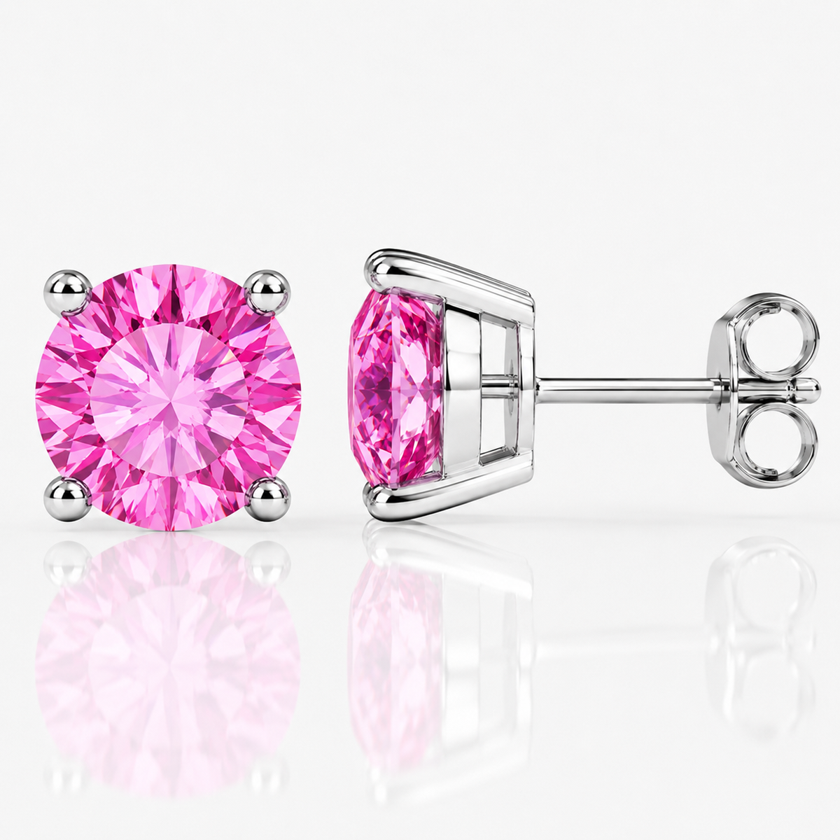Silver four-prong hot pink moissanite stud earrings shown front and side on a white background