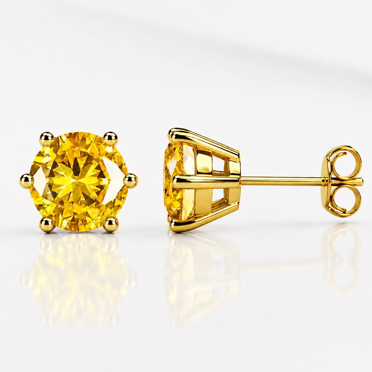 Yellow gold six-prong blue-green moissanite stud earrings shown front and side on a white background