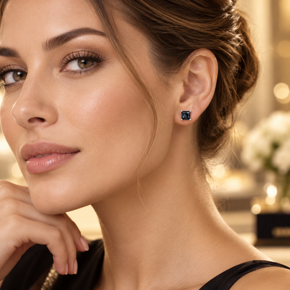 Silver princess cut black moissanite stud earring worn on the ear in a lifestyle portrait