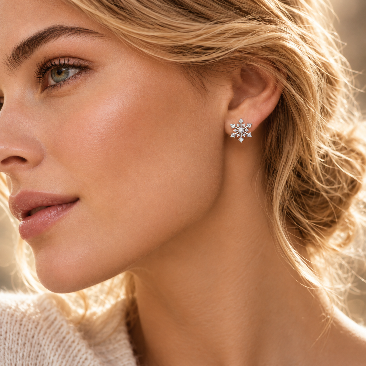 Silver snowflake moissanite stud earring worn on the ear in a lifestyle close-up