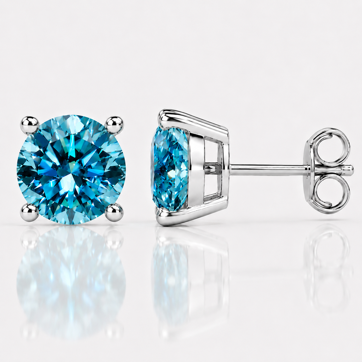 Silver four-prong sea blue moissanite stud earrings shown front and side on a white background