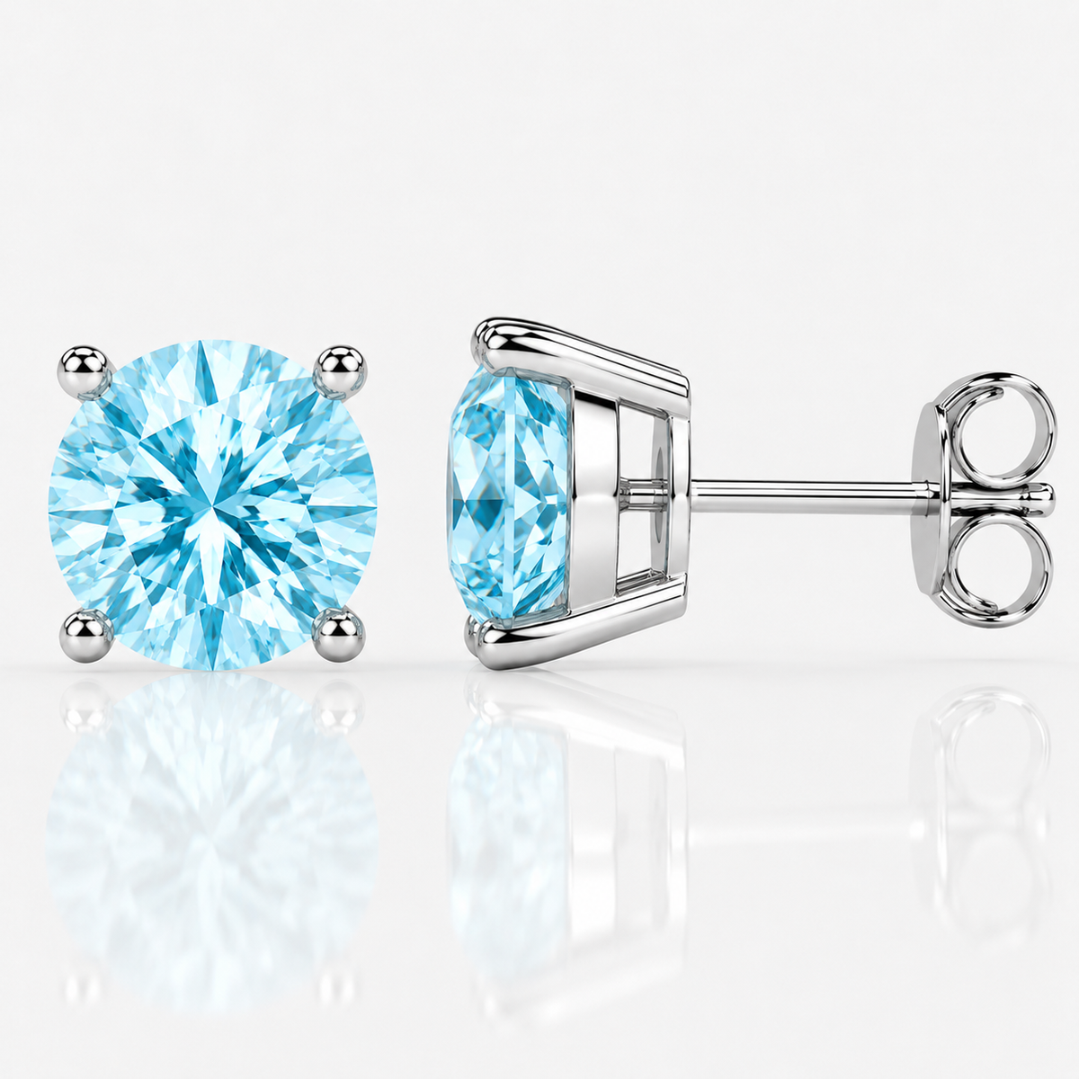 Silver four-prong light blue moissanite stud earrings shown front and side on a white background