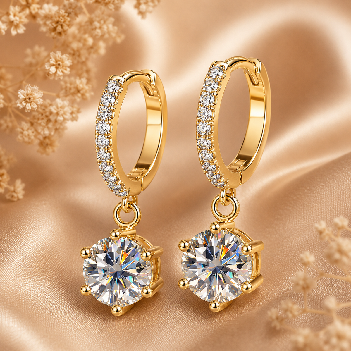 Gold pavé hoop drop earrings with round moissanite stones displayed on champagne satin