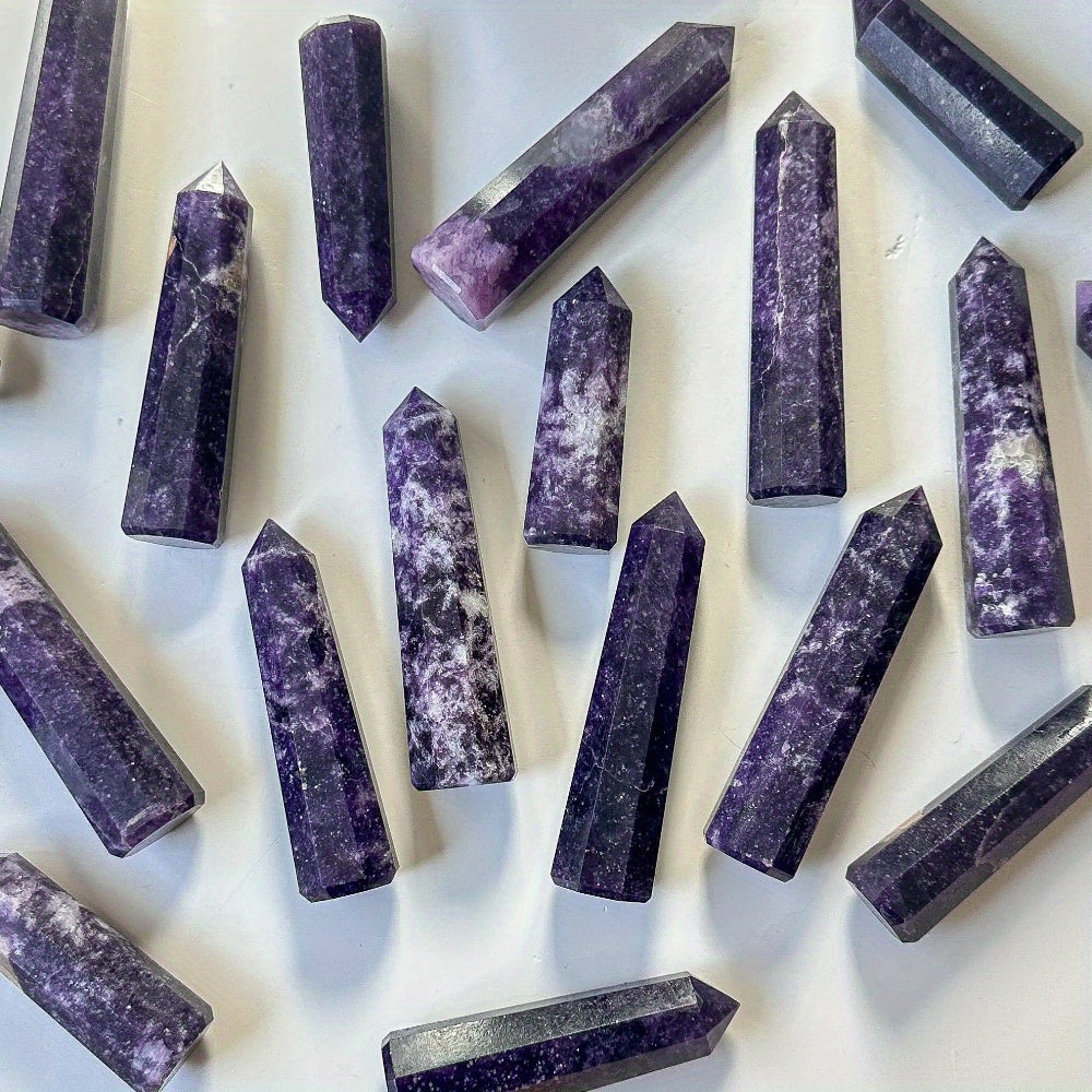 Multiple Lepidolite crystal towers scattered on a white background, highlighting unique purple shades and raw textures for stress relief and crystal healing.