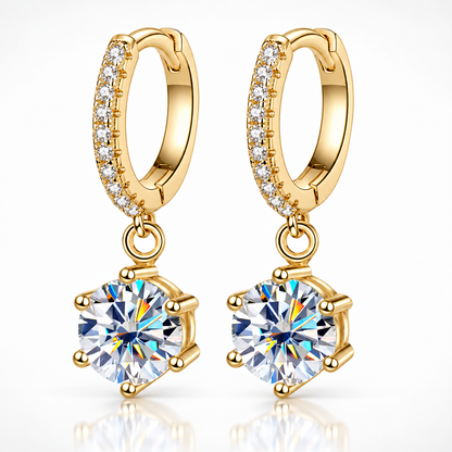 Gold pavé hoop drop earrings with round moissanite solitaires on a white background
