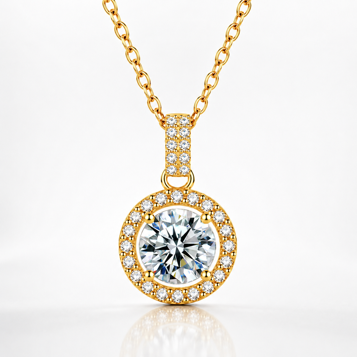Yellow gold round halo moissanite pendant necklace with a pavé halo and pavé bail on a white background.