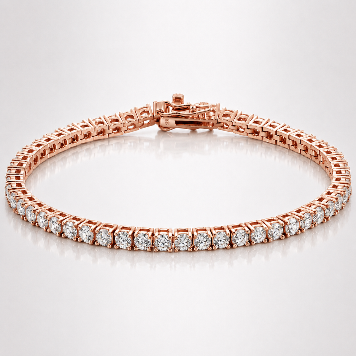 Rose gold-tone classic moissanite tennis bracelet with round stones and box clasp on a white background
