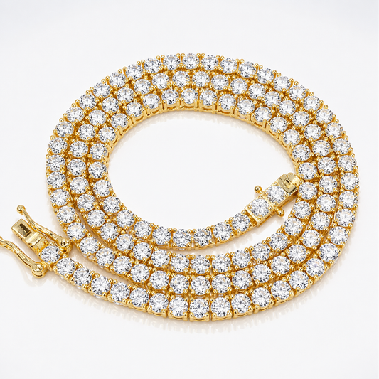 Yellow gold moissanite tennis chain necklace arranged in a coil with the clasp visible on a white background.