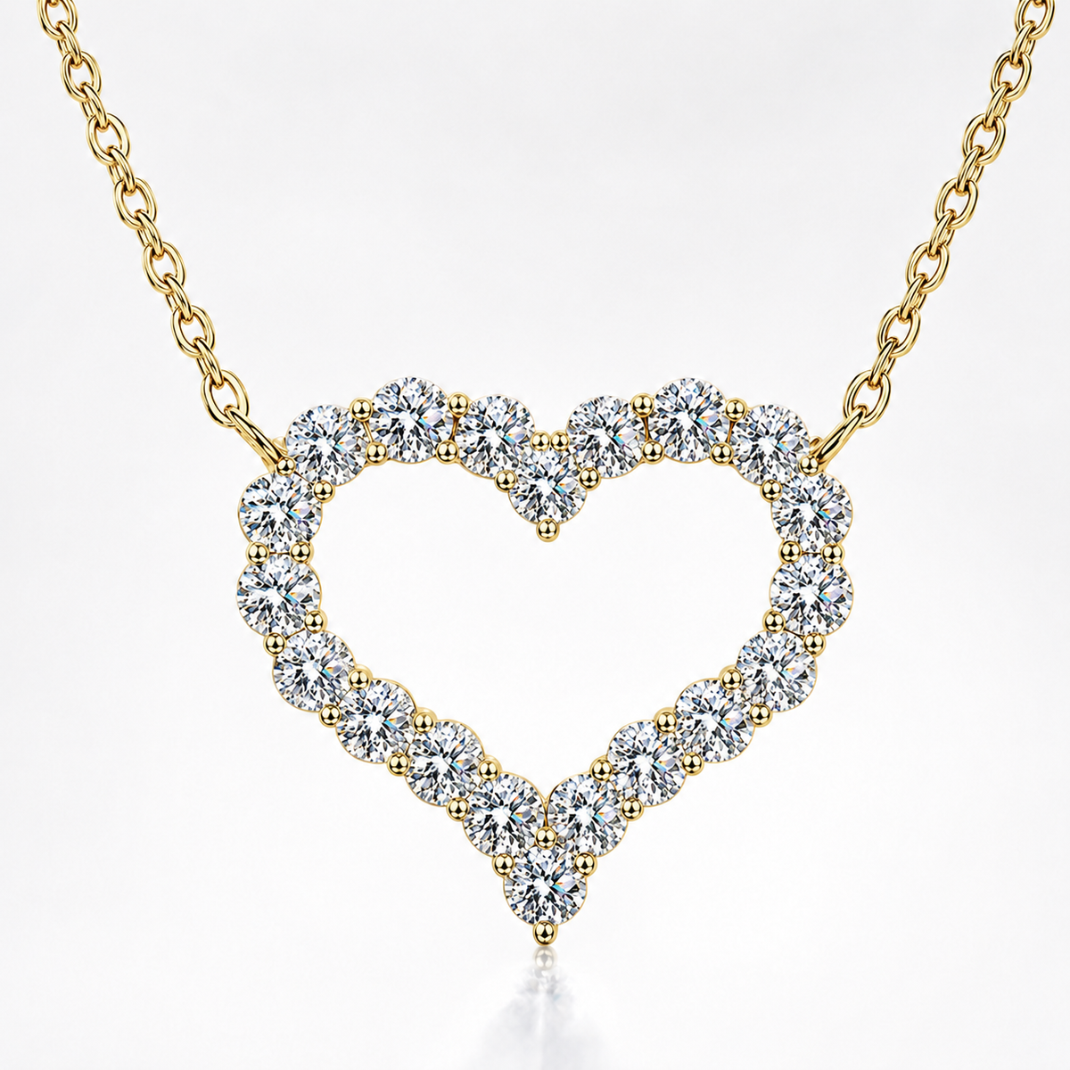 Yellow gold open heart moissanite necklace with round stones set around a heart-shaped pendant on a white background.
