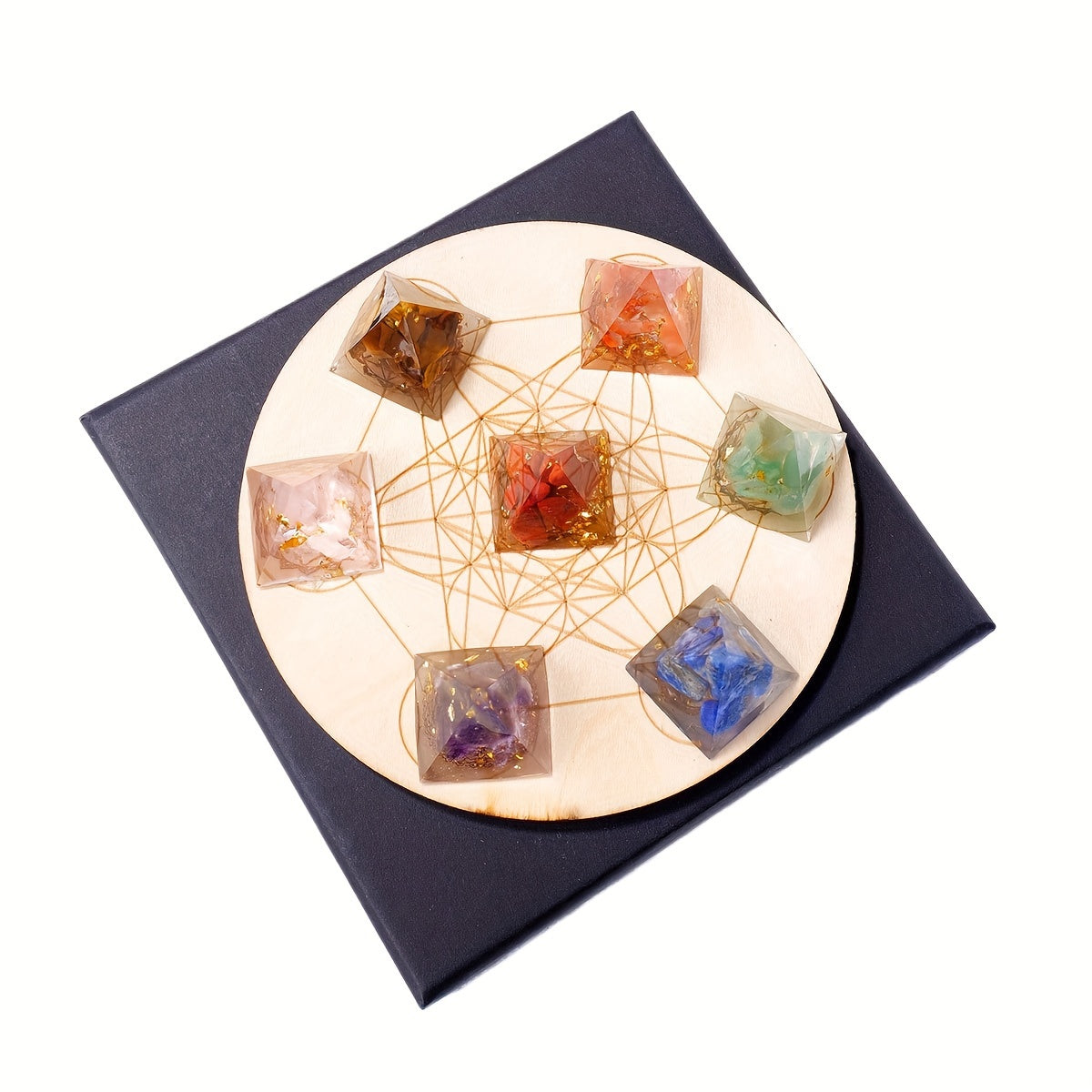 Flat-lay photo of chakra pyramids arranged on a wooden grid atop a gift box, ideal for holistic décor, reiki, and meditation spaces.
