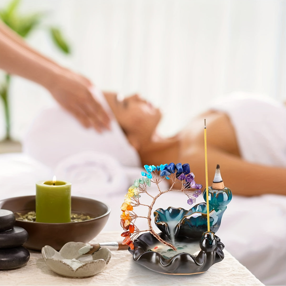 Reiki healing session with chakra crystal incense burner on spa table, promoting energy cleansing and calm