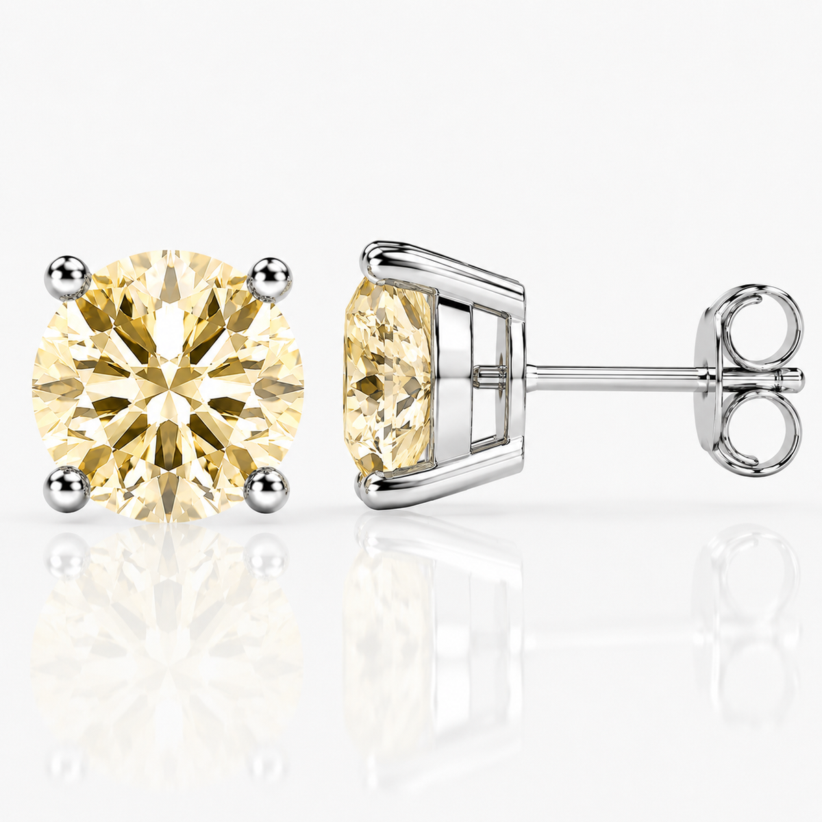 Silver four-prong light yellow moissanite stud earrings shown front and side on a white background