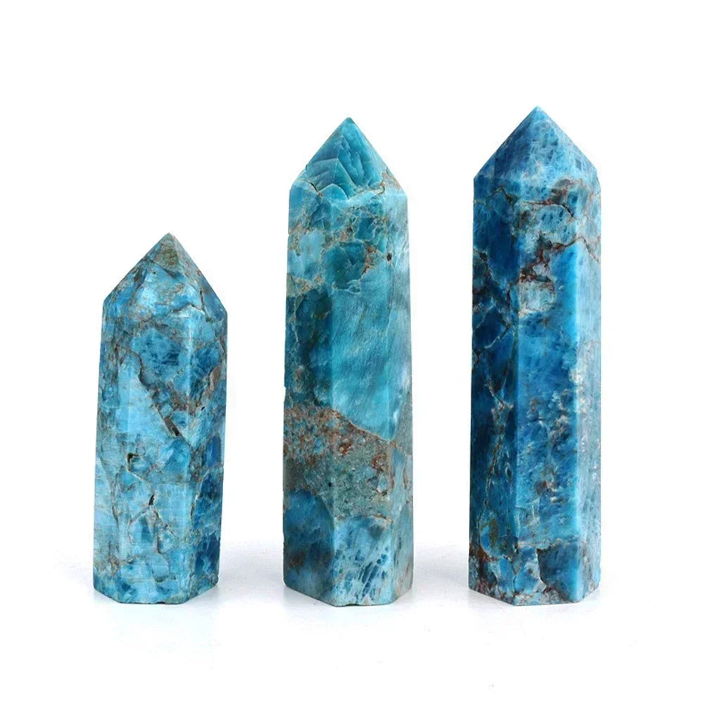 Three blue apatite crystal towers in deep oceanic hues with earthy matrix patterns, standing upright on a white background. Known for enhancing communication and self-expression.