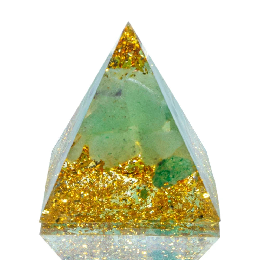A 3cm orgone pyramid featuring calming green fluorite crystals embedded in clear resin with gold foil accents, designed to support clarity, focus, and energetic cleansing.