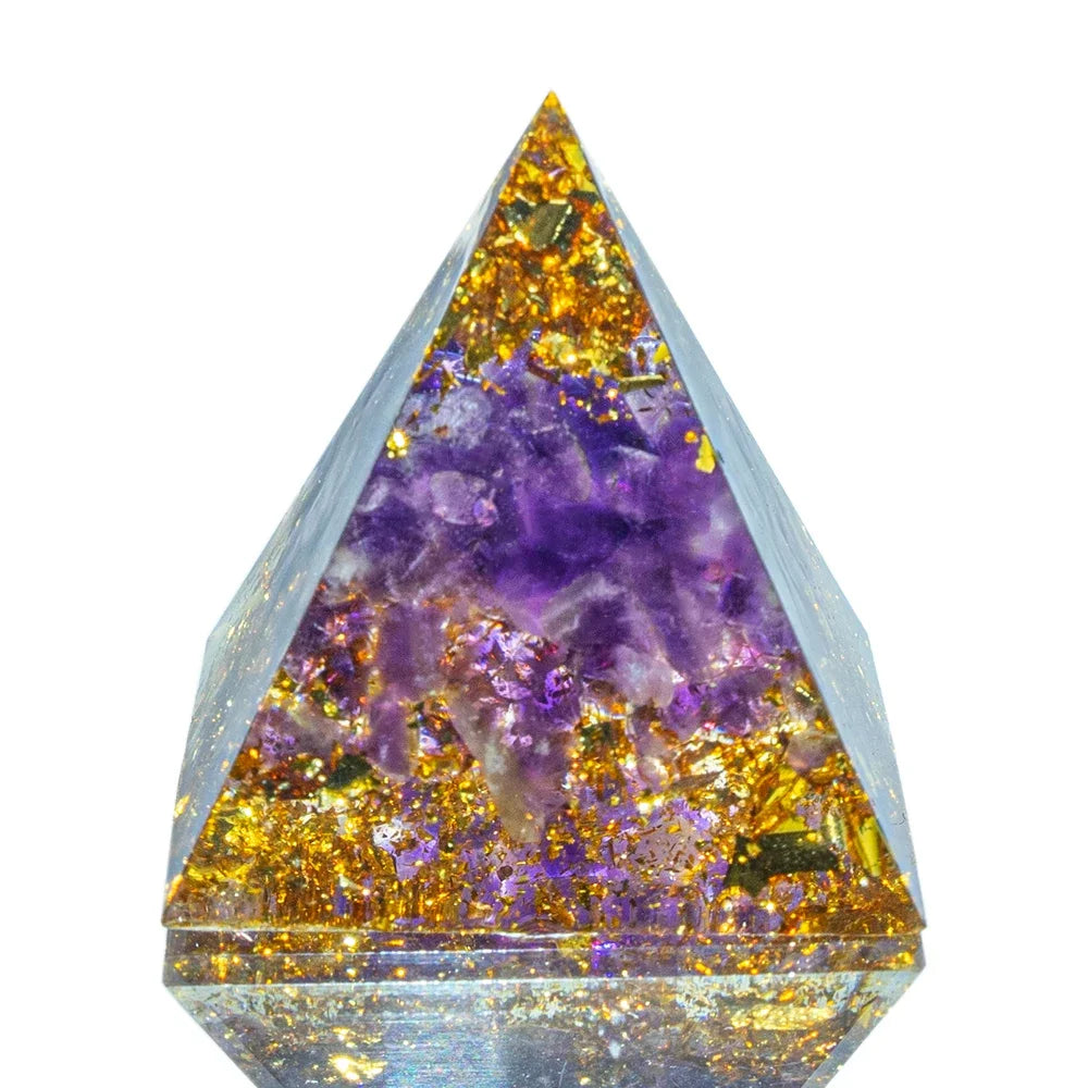 A 3cm orgone pyramid filled with rich purple amethyst crystals and shimmering gold foil, set in clear resin. Designed to support spiritual awareness, intuition, and calming energy.